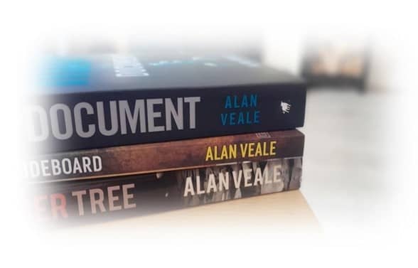A pile of Alan's three published novels.